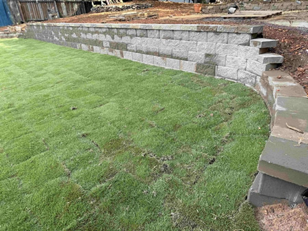 The Benefits of Installing a Retaining Wall on Sloped Properties